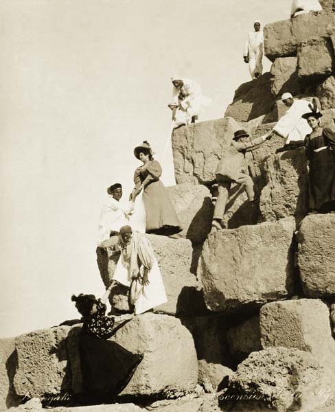 Tourists ascending the pyramids with native guides (b/w photo)  from English Photographer