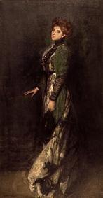 Portrait of a young stationary woman in long dress.