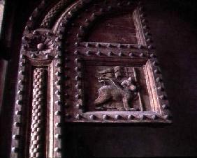 Carved door panel from the Duomoshowing a bear cub carrying a flag