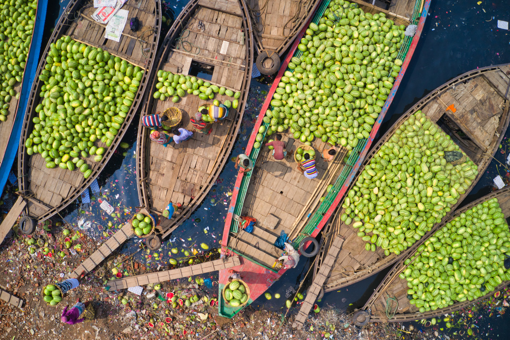 Workers unload watermelons from the boats using big baskets from Azim Khan Ronnie