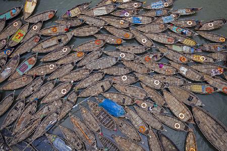 Boats laid out like petals with life saving rings