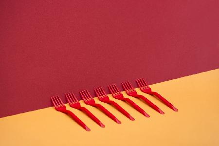 Very simple still life with red forks