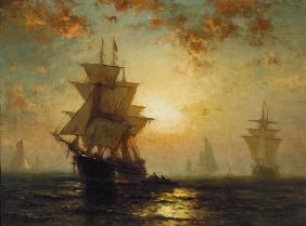 navires à voile avec un coucher de soleil