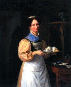 A young Munich waitress in dress and bolt bonnet serves the breakfast
