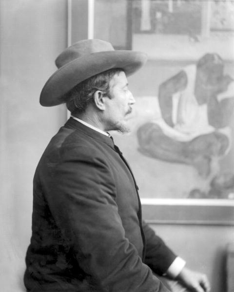 Paul Gauguin (1848-1903) in front of his canvases (b/w photo)  from French School