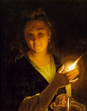 Junge Frau mit brennender Kerze.