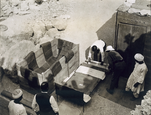 Moving the centre portion of one of the beds or couches from the Tomb of Tutankhamun, Valley of the  from Harry Burton