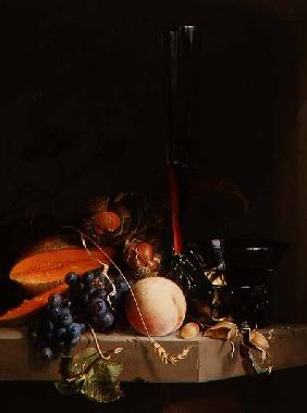 Still life of fruit on a ledge with a roemer and a wine glass