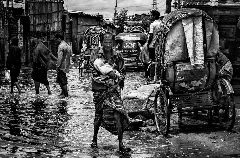 Man holding his child in the flooded streets of Bangladesh from Joxe Inazio Kuesta Garmendia