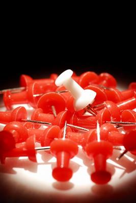 Red push pins, close-up from Krzysztof Gapys