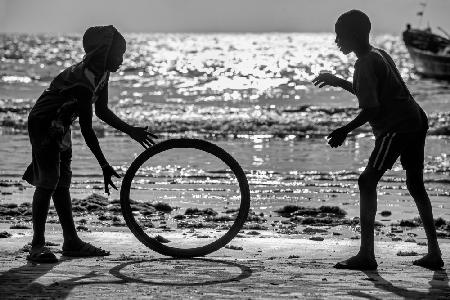 Africa kids playing with old wheel
