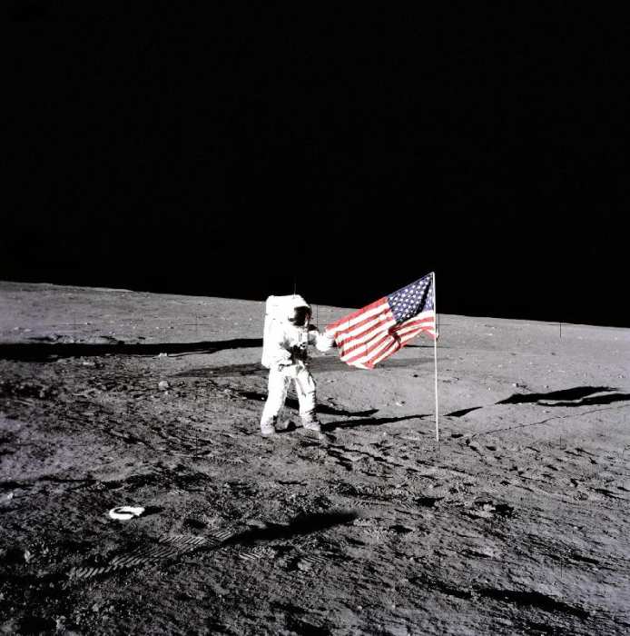 Apollo 12 Astronaut Charles Pete Conrad stands beside the United States flag after is was unfurled o from 
