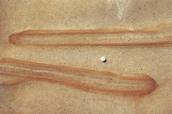 Embossed brown fingers on rock with pebble (photo)  from 