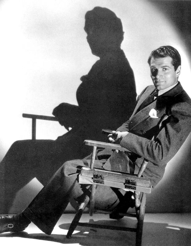 English Actor Laurence Olivier seated on a chair's director from 