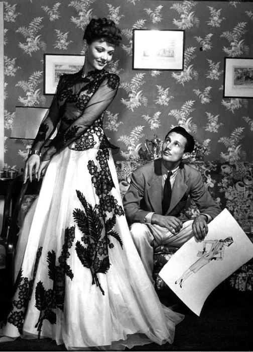 fashion designer Oleg Cassini showing his drawings to Gene Tierney to show her the clothes for film  from 