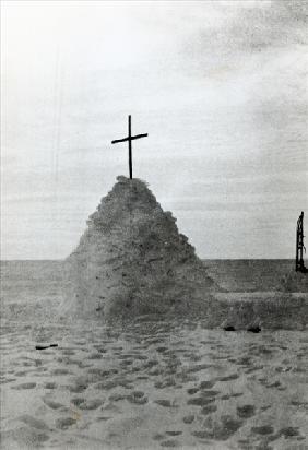 The tomb of Scott of the Antarctic and his companions, Bowers and Wilson, marked by a mound of snow,