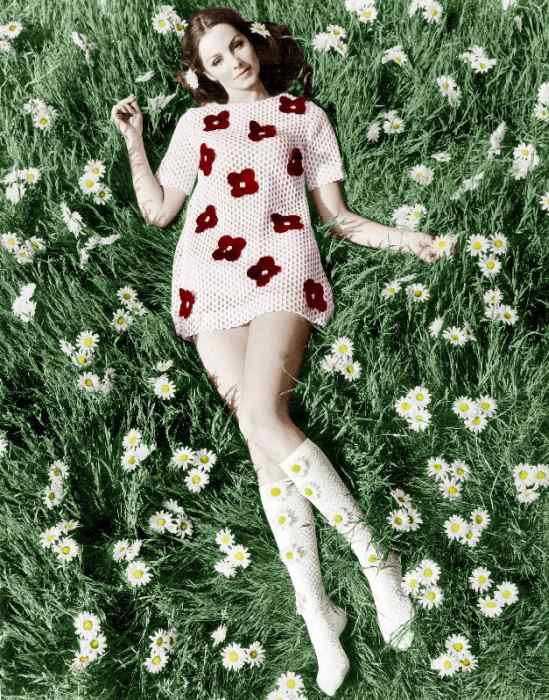 Young model Biddy Lampard in the grass wearing a short dress inspired by Courreges colourized docume from 