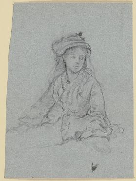 Luise Scholderer in Rüschenjacke und mit Hut, Halbfigur, sitzend