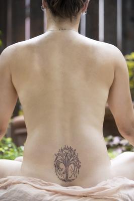 Back of a nude woman meditating from Scott Griessel