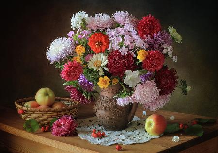 Still life with a bouquet of flowers and apples