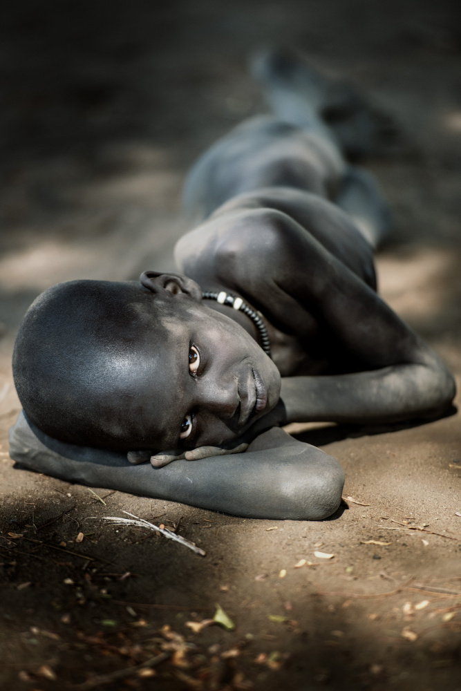Young Mundari boy at rest from Trevor Cole